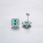 Elegant Emerald - Cut Aqua Blue CZ Halo Stud Earrings in Sterling Silver - NAFALUXE