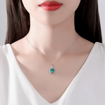 Elegant Emerald - Cut Green CZ Halo Pendant Necklace in Sterling Silver - NAFALUXE